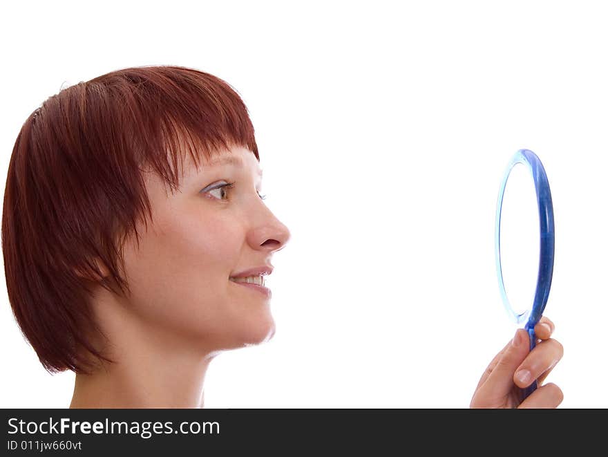 Portrait of the red-haired girl with a mirror in a high key. Portrait of the red-haired girl with a mirror in a high key.