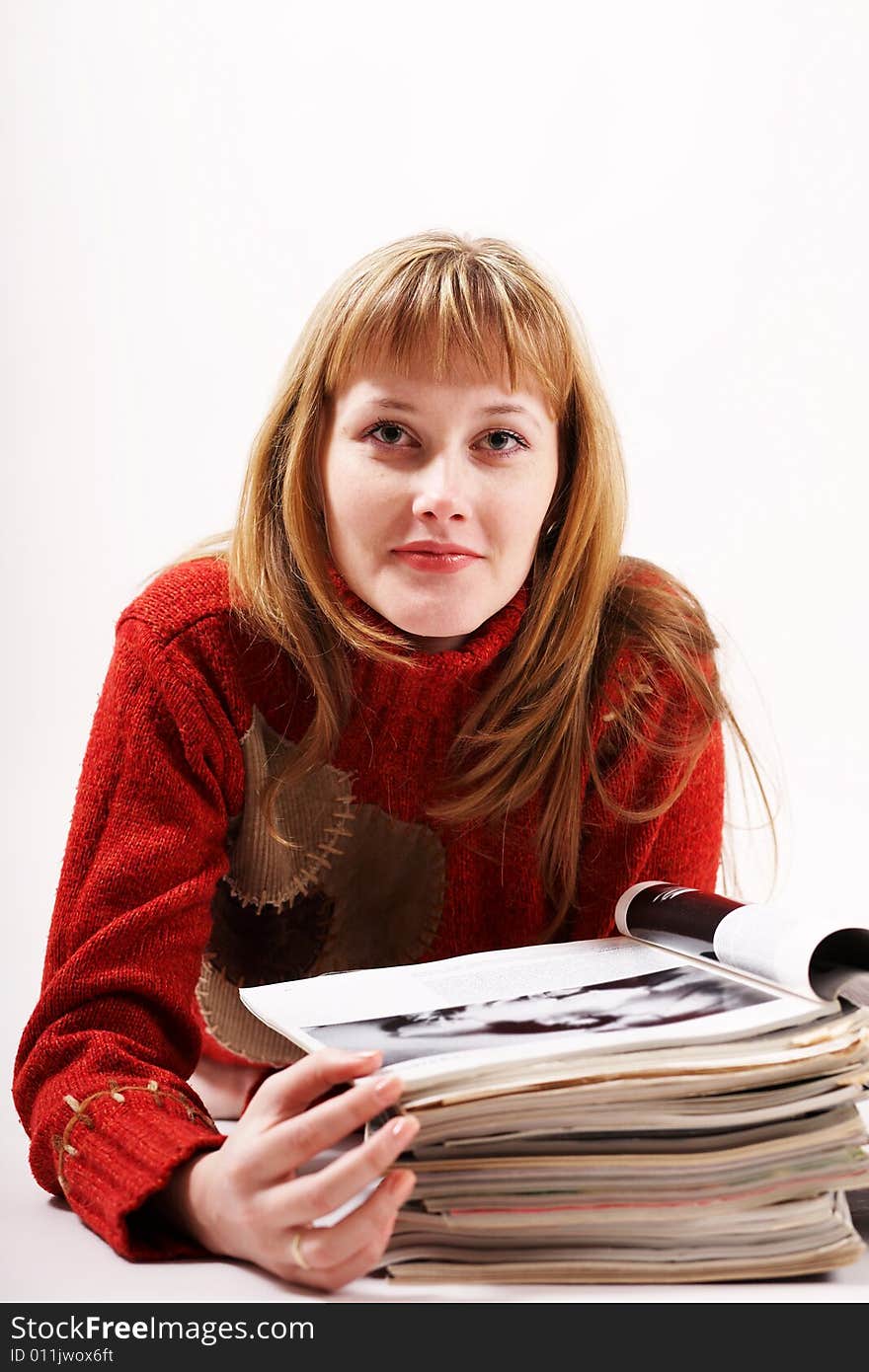 An image of a girl reading magazines. An image of a girl reading magazines