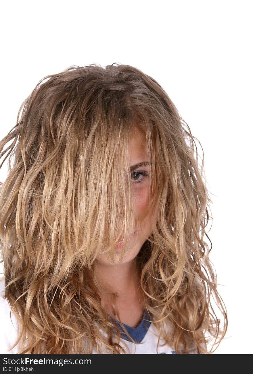 Young girl hiding behind her long, bushy hair. Young girl hiding behind her long, bushy hair