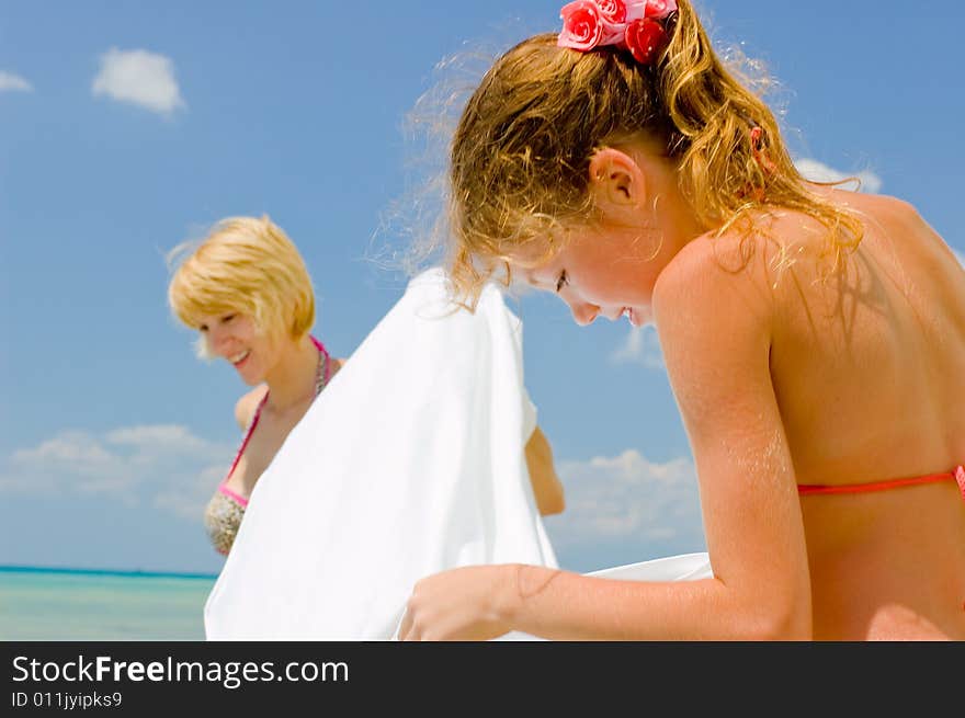 Mother and daughter having fun on the beach