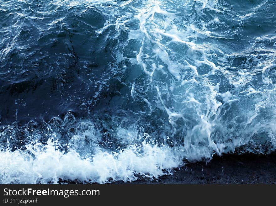 An image of a wave in blue sea. An image of a wave in blue sea