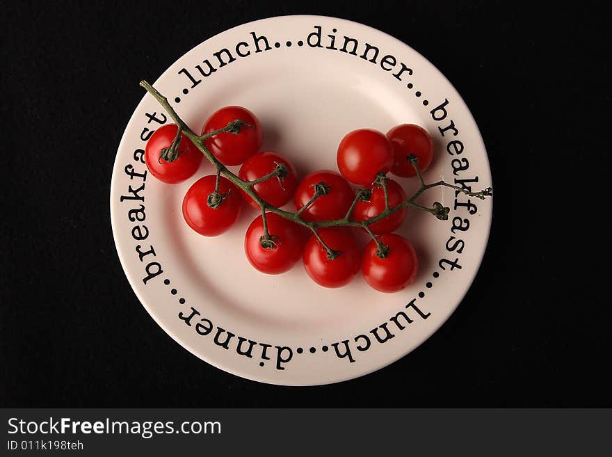 Red cherry tomatoes on the plate