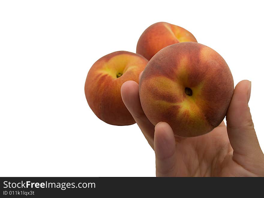 Two peach and one peach in a hand. Two peach and one peach in a hand