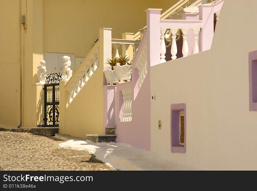 Traditional old Greek pastel painted stucco staircases in Santorini. Traditional old Greek pastel painted stucco staircases in Santorini