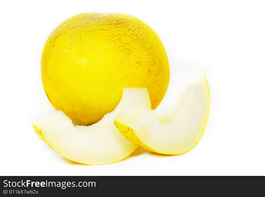 Yellow ripe melon and two slices on white