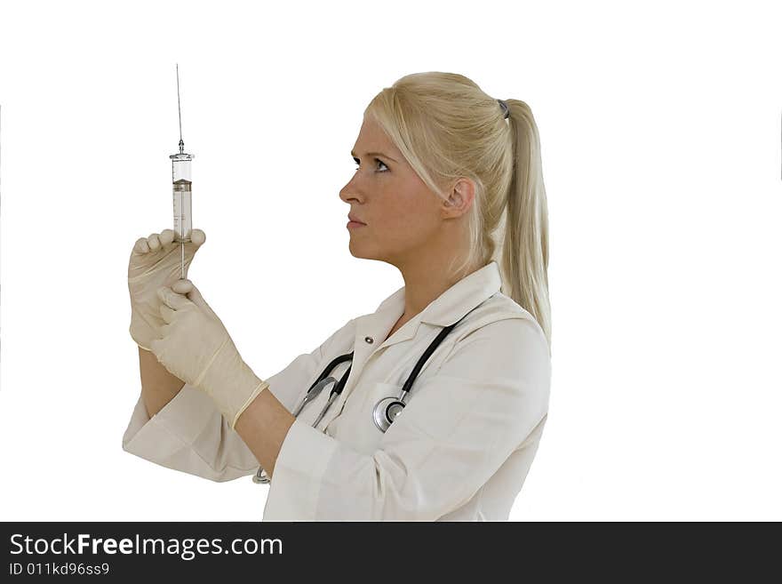 A young female doctor/nurse  prepares to make an injection isolated on white backgroun