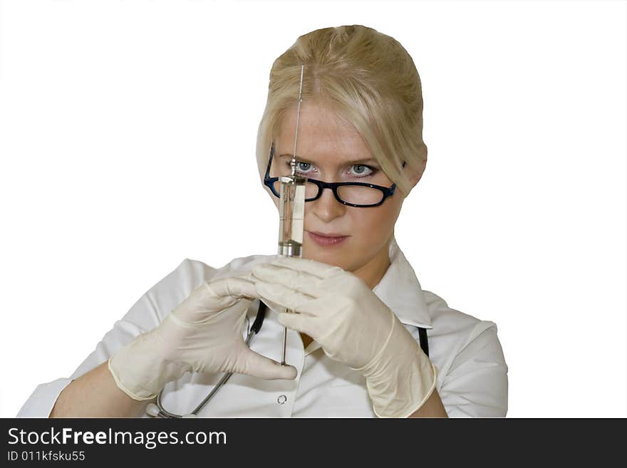 A young female doctor/nurse is looking straight at the syringe needle isolated on the white background. A young female doctor/nurse is looking straight at the syringe needle isolated on the white background