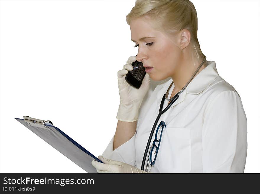 A young female doctor/nurse talking over the phone. A young female doctor/nurse talking over the phone