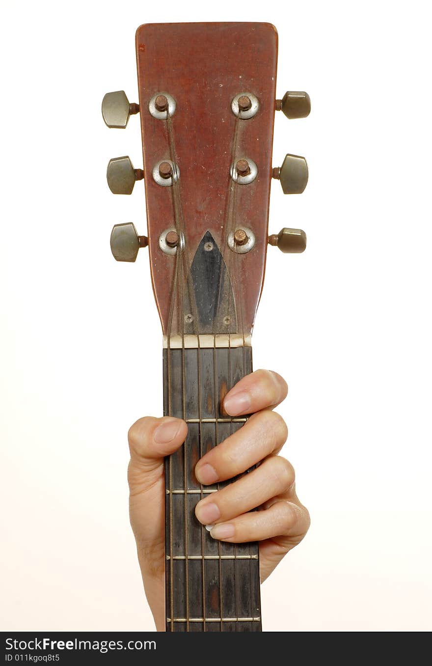 One hand is holding the old guitar. One hand is holding the old guitar