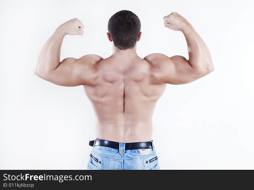 Young man athlete with perfect body at white background. Young man athlete with perfect body at white background