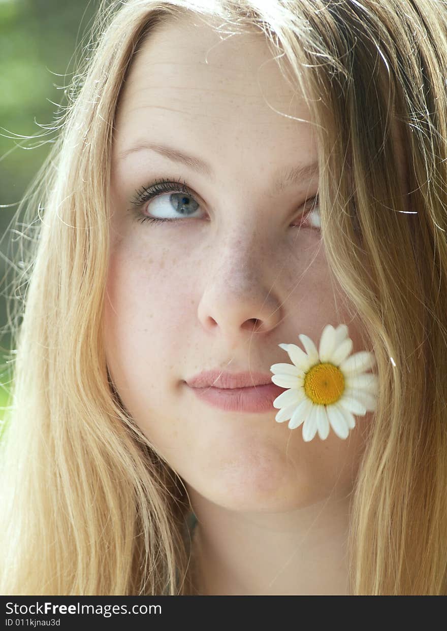 Expressive face of a model with flower in her mouth. Expressive face of a model with flower in her mouth