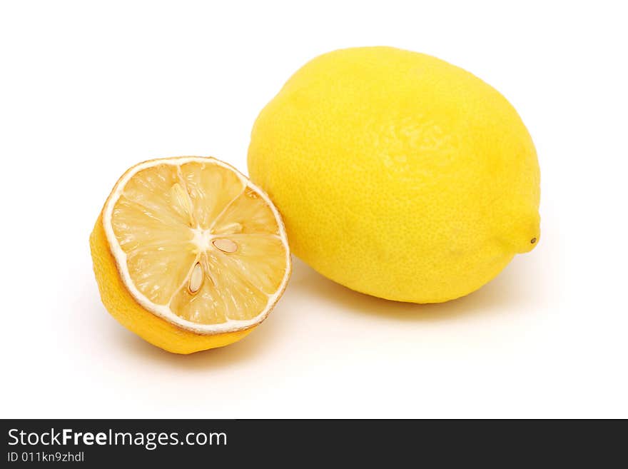 A dried half lemon and the fresh one on white background. A dried half lemon and the fresh one on white background.