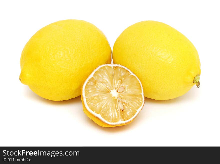 Half dried lemon put together with two fresh lemons on white background.