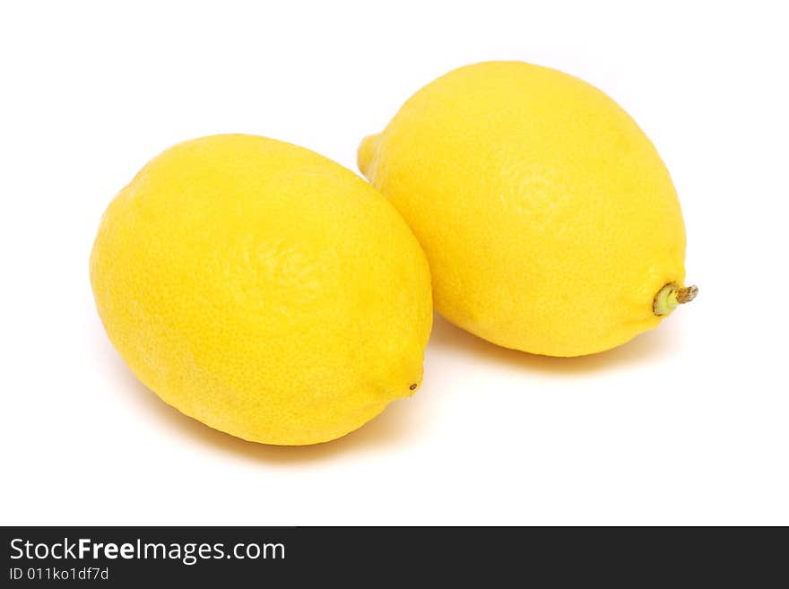 Two fresh yellow lemons isolated on white background.