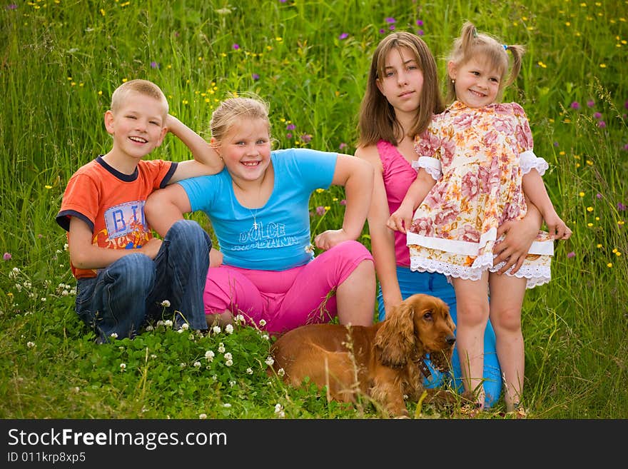 Happy children sit next a dog