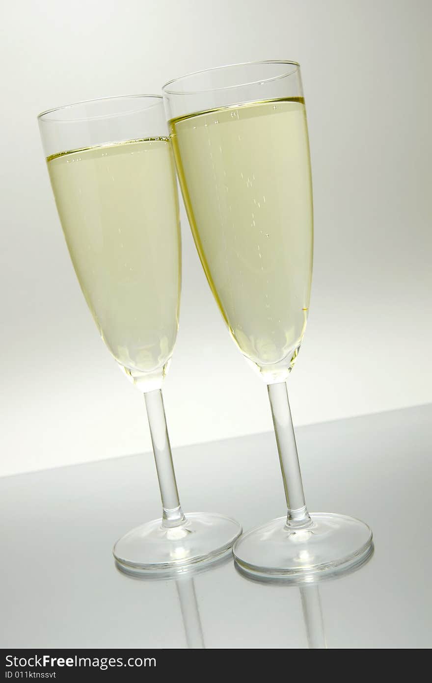 Flutes of sparkling wine isolated against a white background