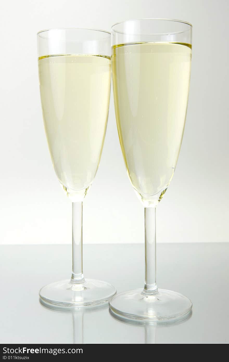 Flutes of sparkling wine isolated against a white background