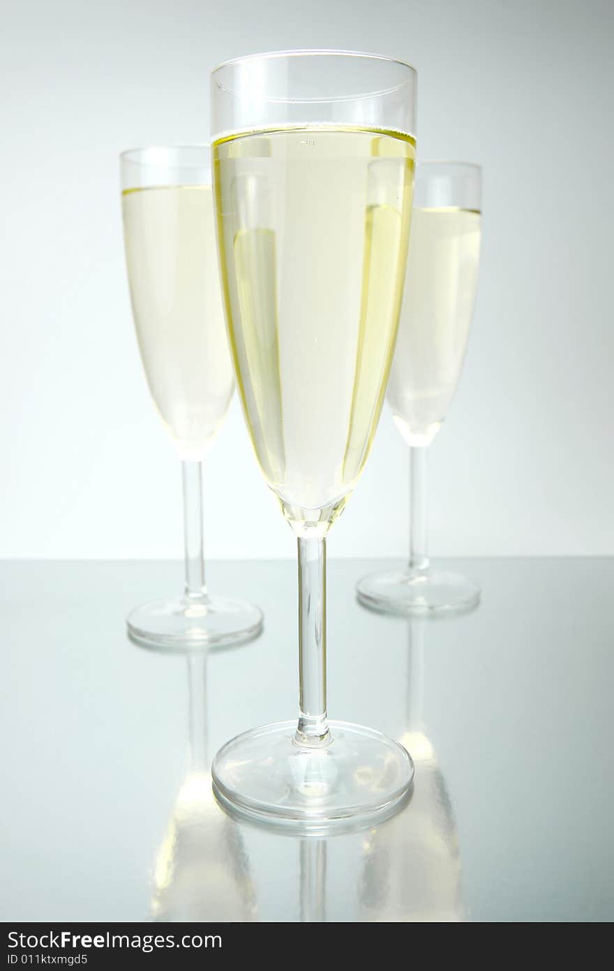 Flutes of sparkling wine isolated against a white background