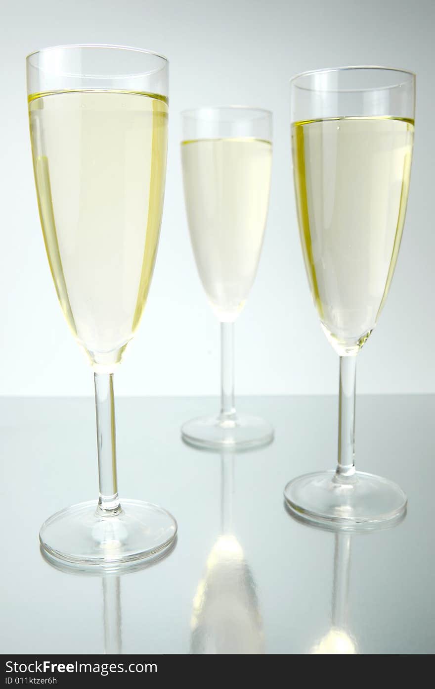 Flutes of sparkling wine isolated against a white background