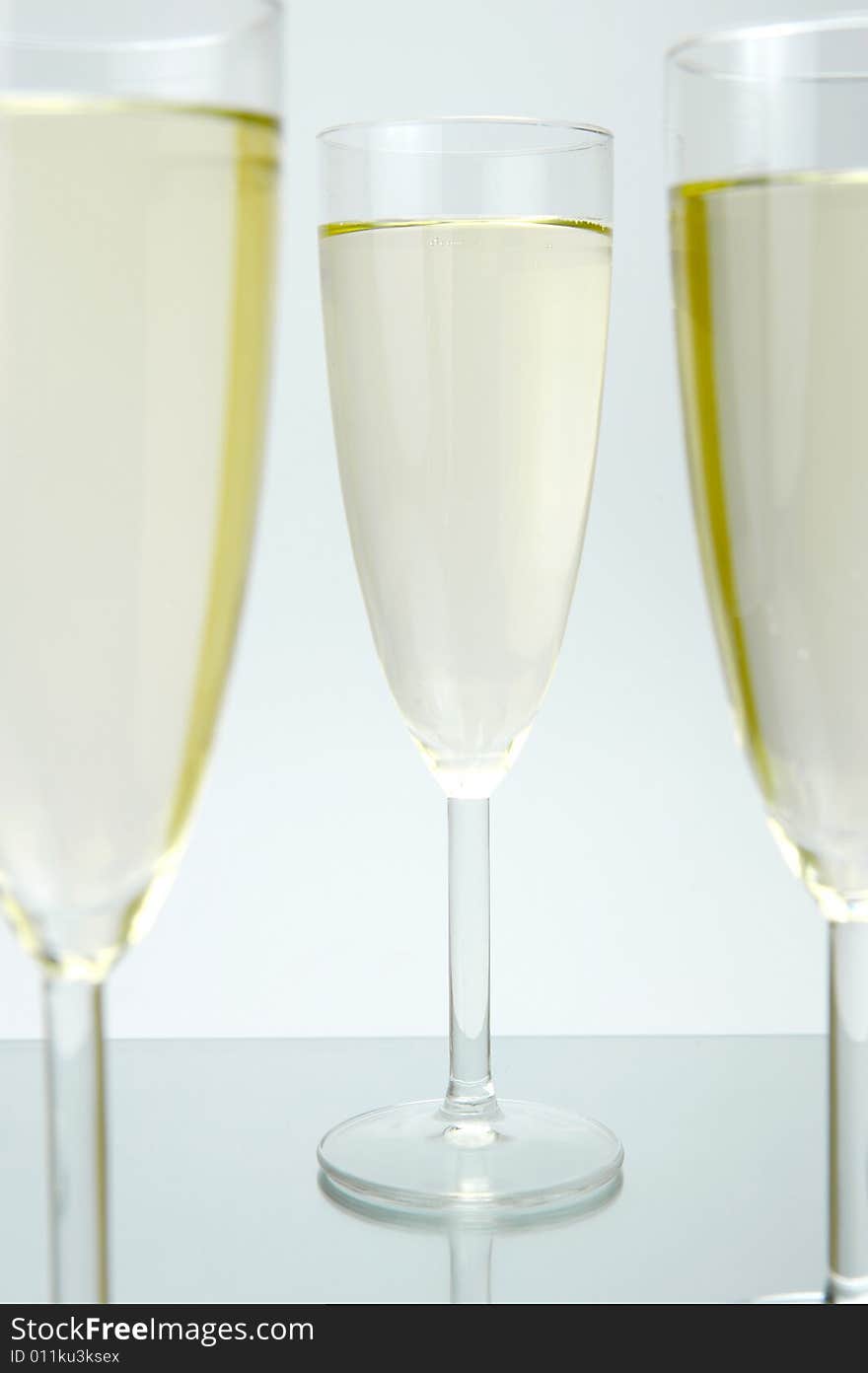 Flutes of sparkling wine isolated against a white background