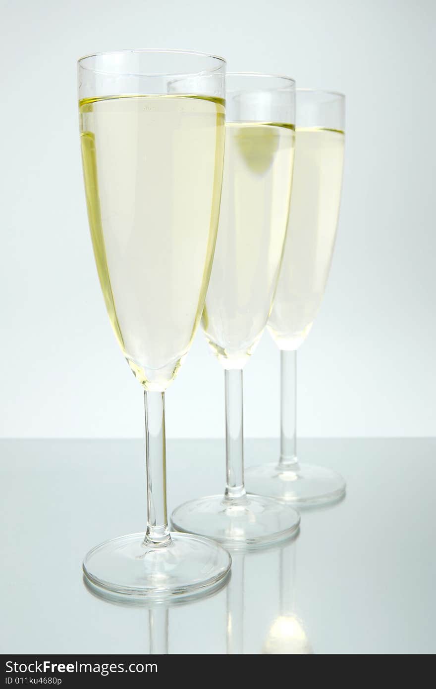 Flutes of sparkling wine isolated against a white background