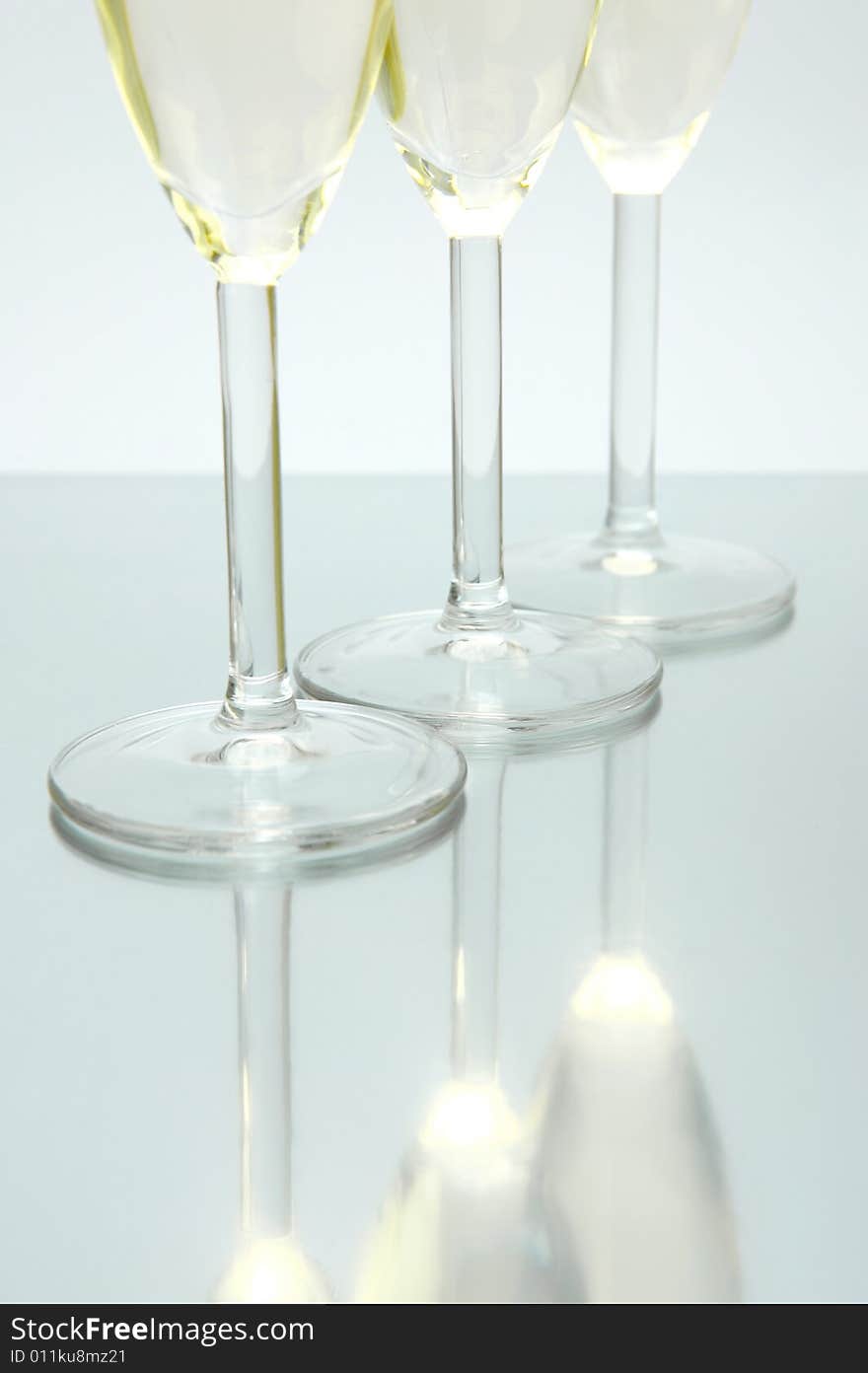 Flutes of sparkling wine isolated against a white background