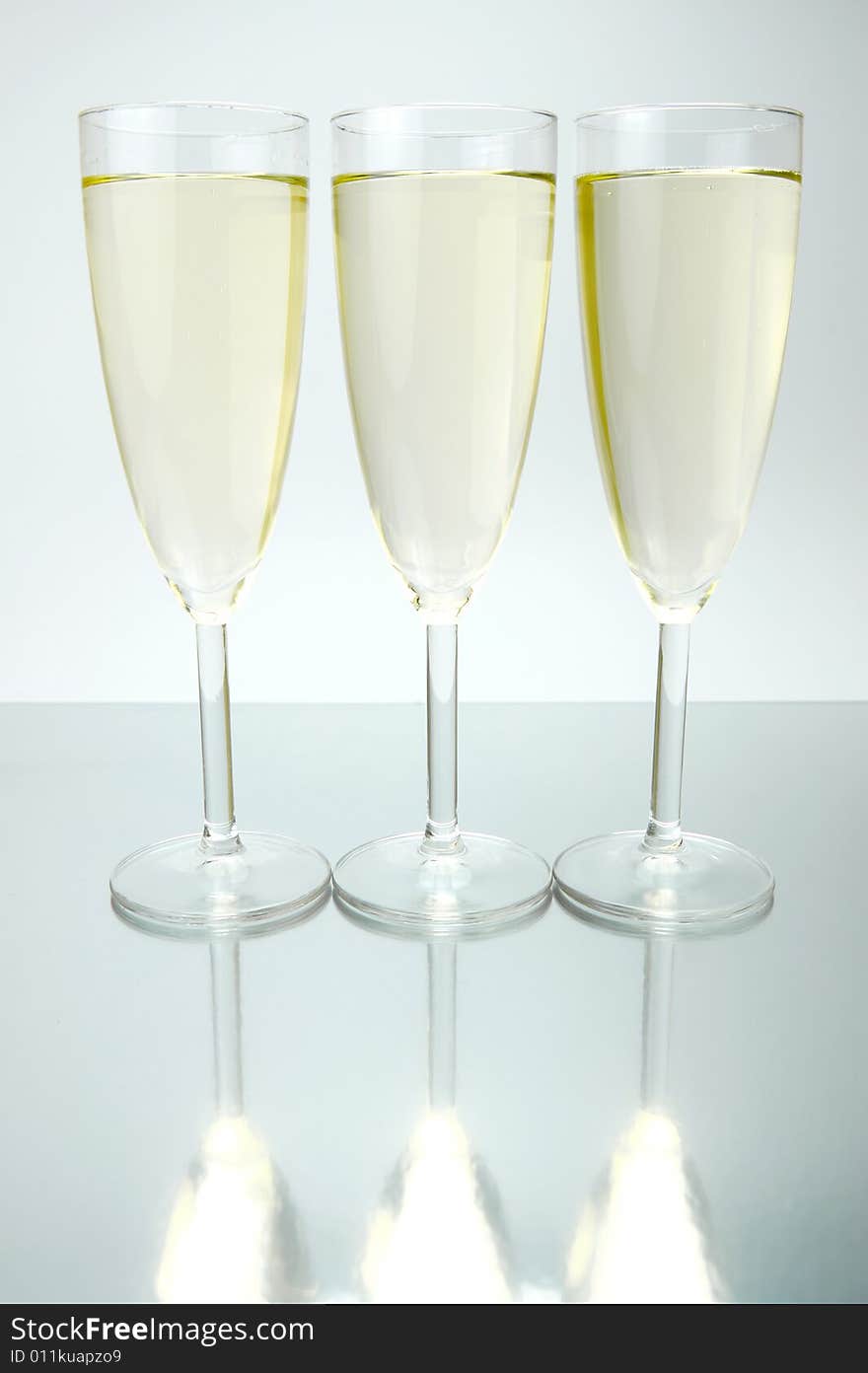 Flutes of sparkling wine isolated against a white background