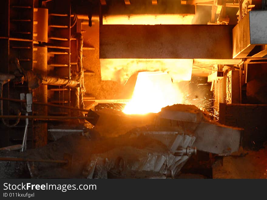 Glowing, molten hot steel. Stell casting. Glowing, molten hot steel. Stell casting.