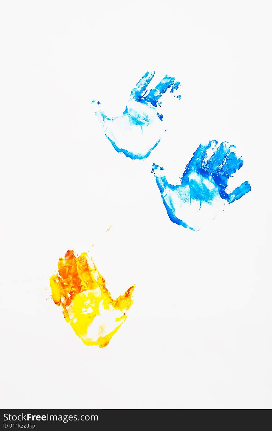 Child's hand prints in blue and yellow on the wall. Child's hand prints in blue and yellow on the wall