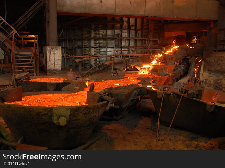 Glowing, molten hot steel. Stell casting. Glowing, molten hot steel. Stell casting.