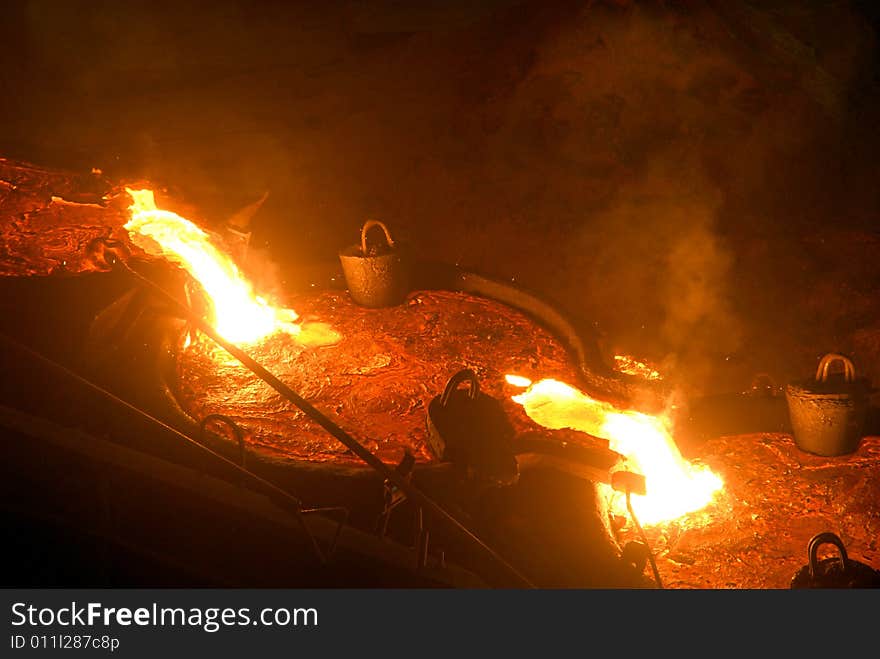 Glowing, molten hot steel. Stell casting. Glowing, molten hot steel. Stell casting.