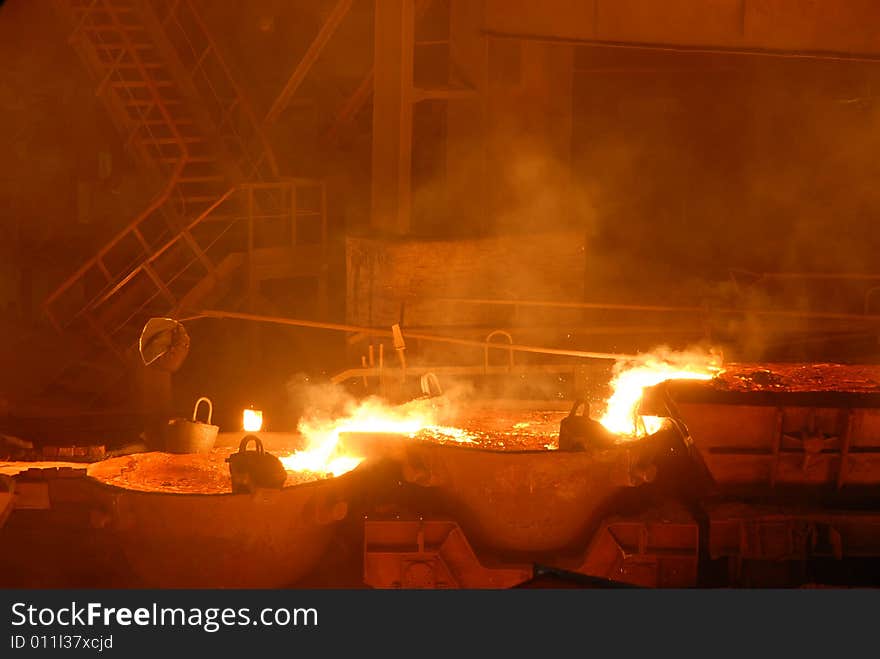 Glowing, molten hot steel. Stell casting. Glowing, molten hot steel. Stell casting.