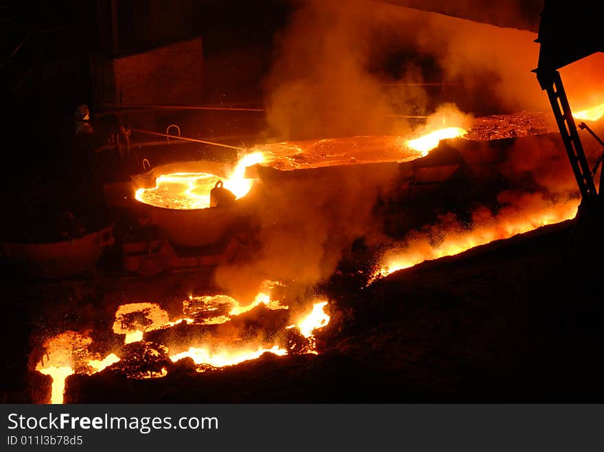 Glowing, molten hot steel. Stell casting. Glowing, molten hot steel. Stell casting.