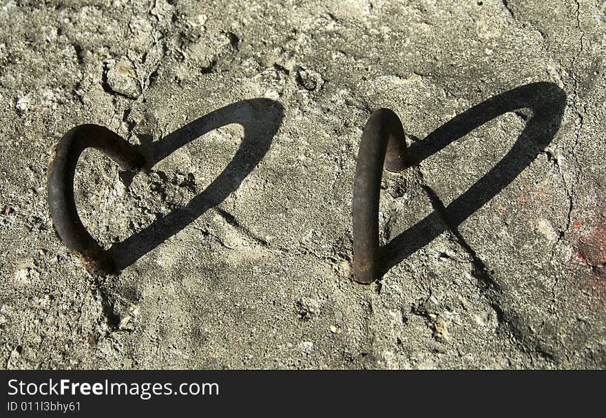 Shadow from metallic crampon on the concrete. Shadow from metallic crampon on the concrete