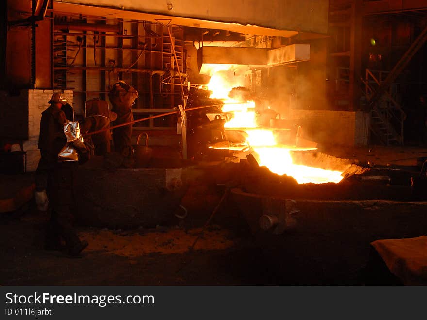 Glowing, molten hot steel. Stell casting. Glowing, molten hot steel. Stell casting.