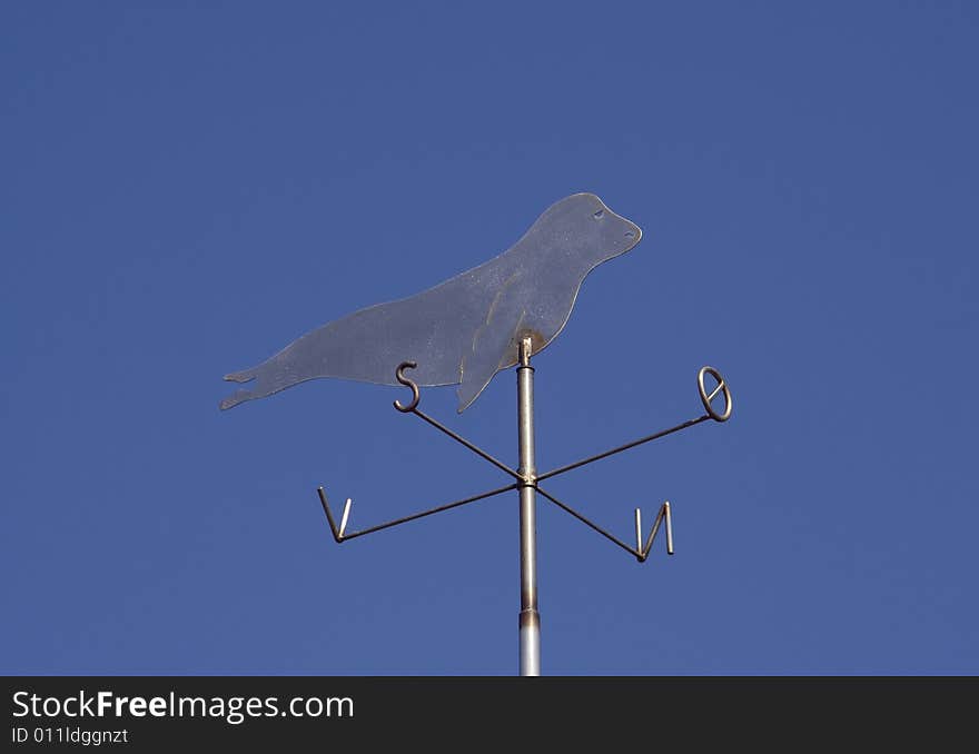 Weather vane - seal - against the blue sky