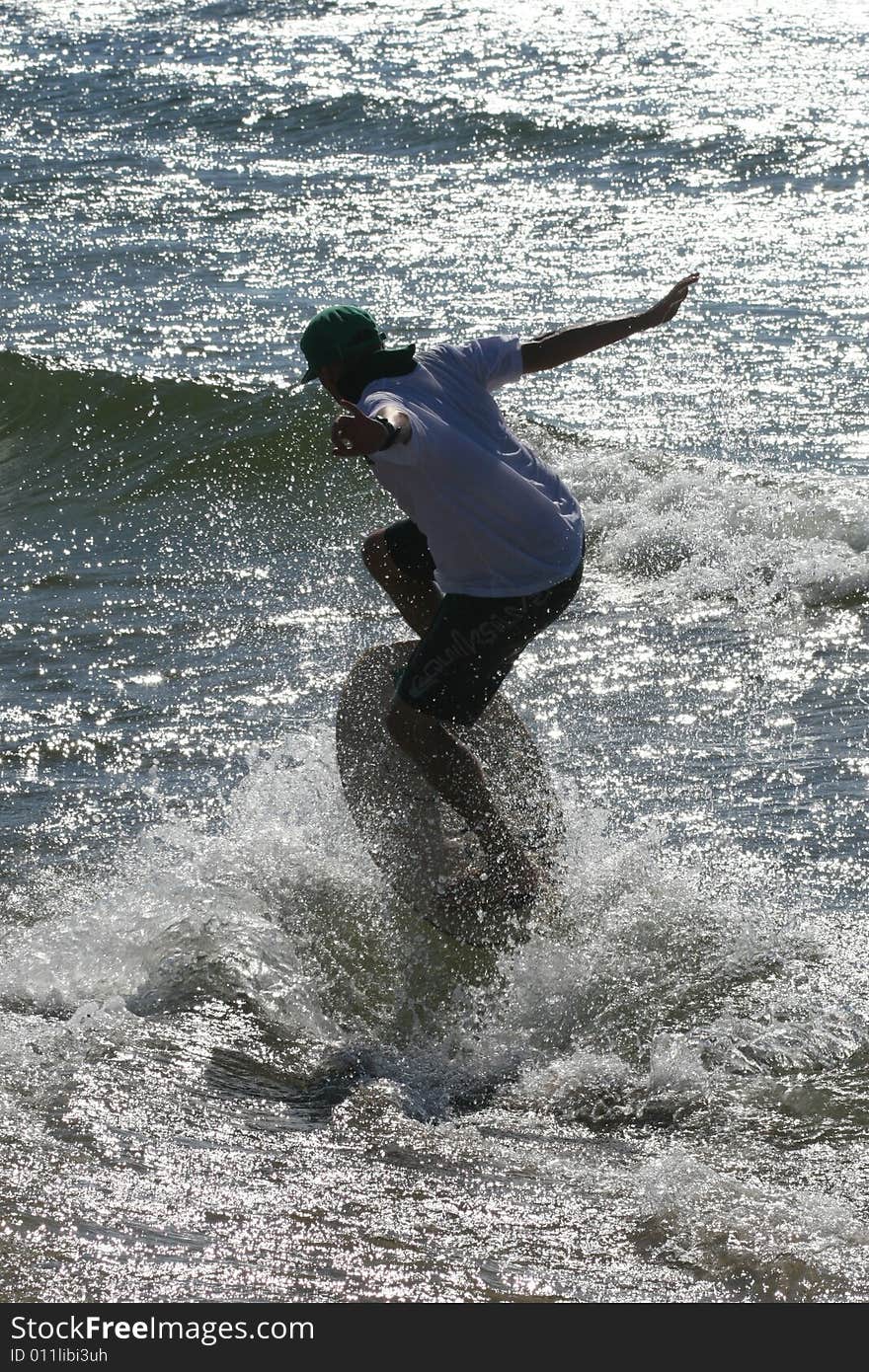 Skimboarder on the Baltic beach. Skimboarder on the Baltic beach