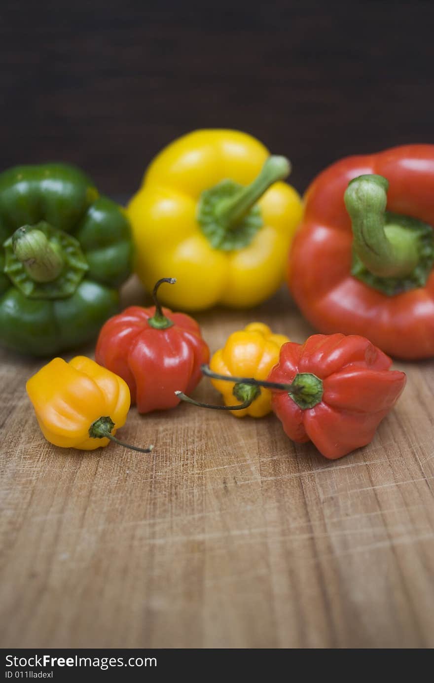 Some fresh paprikas on a wooden board