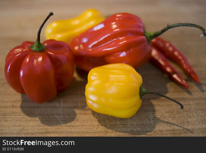 Some fresh chilis on a wooden board