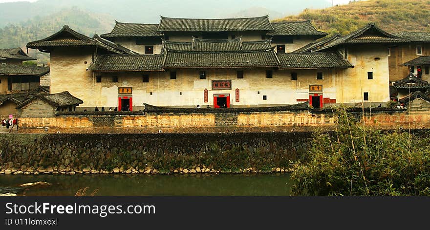 Fujian Tulou - Fuyu Tower. The Earth Tower of Hakka has a long history. As early as one thousand years ago, some of the original Hakka migrated and settled at the sparse Yongding area. In order to protect themselves against bandits and wild beasts, they used local materials to build tall, multi-storey circular earthen buildings where a whole family or clan could live in. These are the earth towers that we see today.