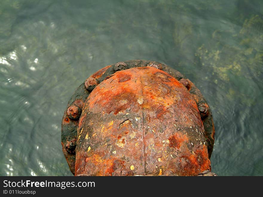 Rusty water drain pipe going into water. Rusty water drain pipe going into water