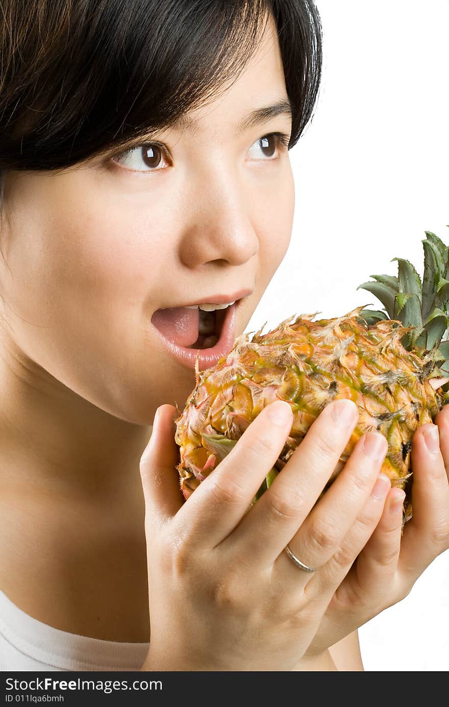 Young asian female holding a ripe and fresh pineapple. isolated picture shot in studio. Young asian female holding a ripe and fresh pineapple. isolated picture shot in studio