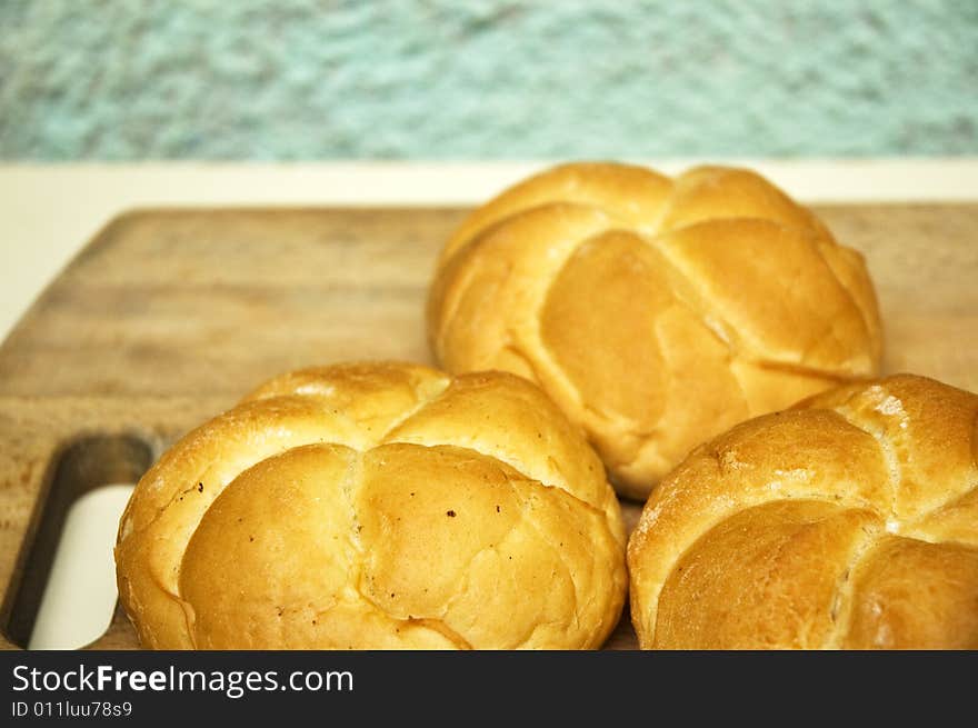 Bread roll on kitchen board.