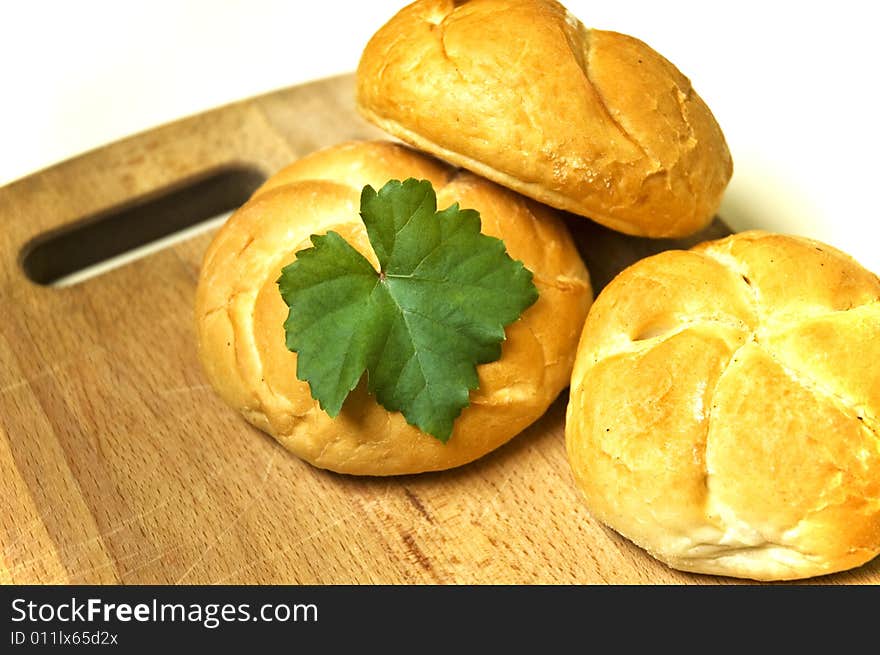 Bread roll on kitchen board.