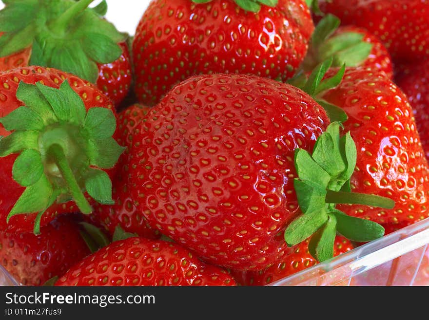 Fresh, ripe strawberry in a transparent tray