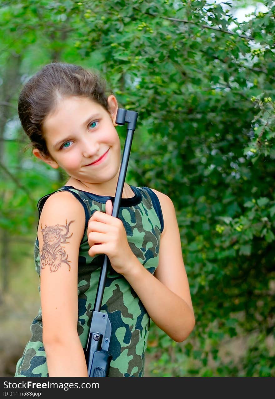 Girl with gun in wood for your design