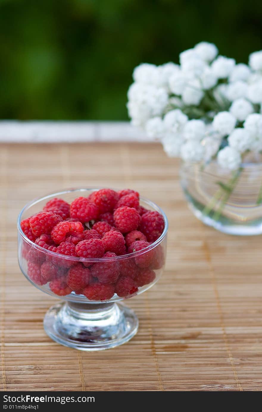 Raspberry in a transparent cup