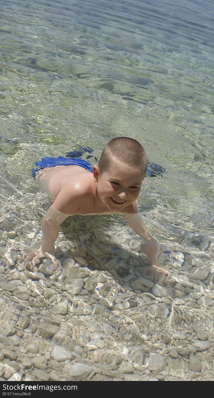 Happy Kid Playing In Water