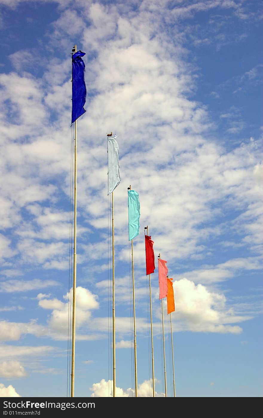 Six flags fluttering on the wind over blue sky