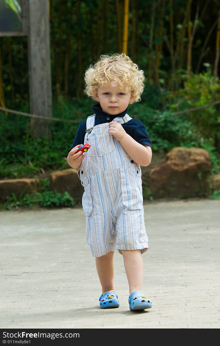 Cute young boy walking in summer